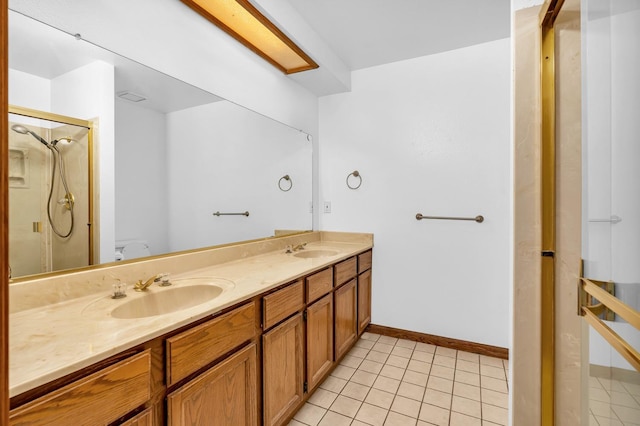 bathroom with toilet, vanity, tile patterned floors, and a shower with door