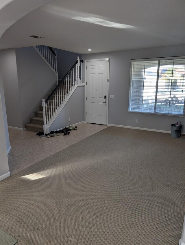 view of carpeted foyer entrance