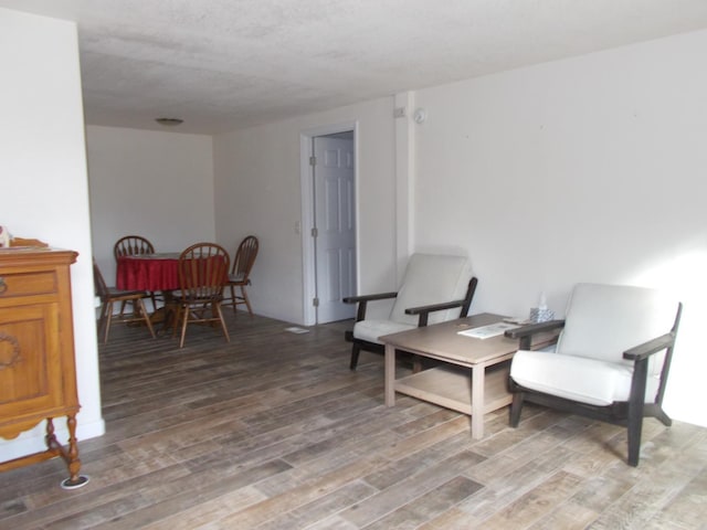 sitting room with wood-type flooring