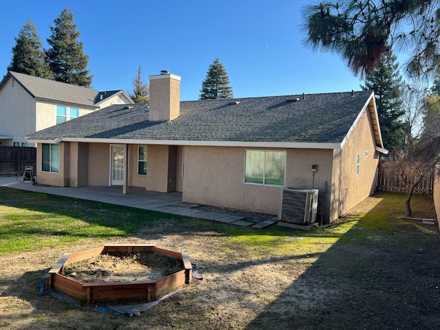 back of house with a patio, central air condition unit, and a lawn