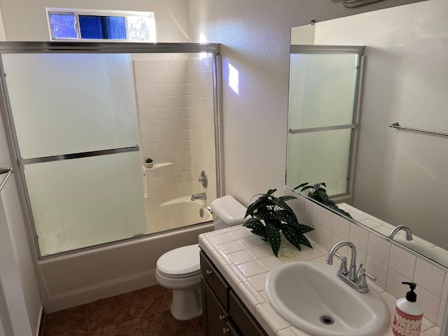 full bathroom featuring vanity, tile patterned flooring, shower / bath combination with glass door, and toilet