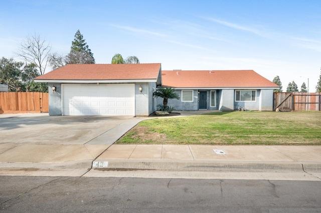 single story home featuring a garage and a front lawn