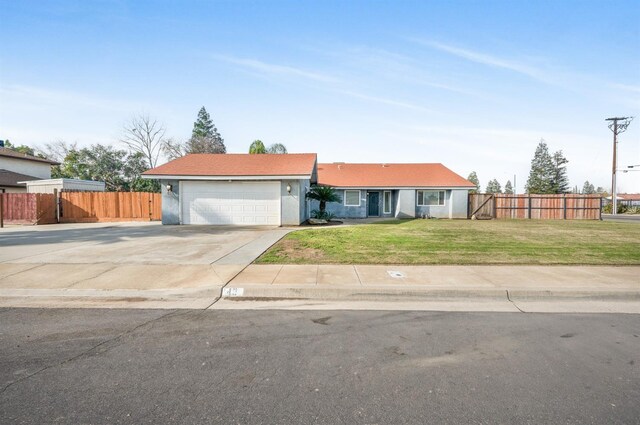 ranch-style house featuring a garage and a front yard