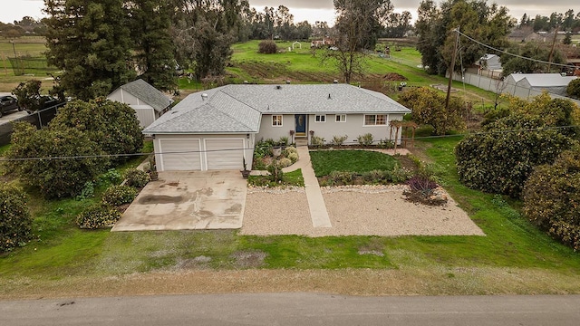 view of front of house featuring a garage and a front lawn