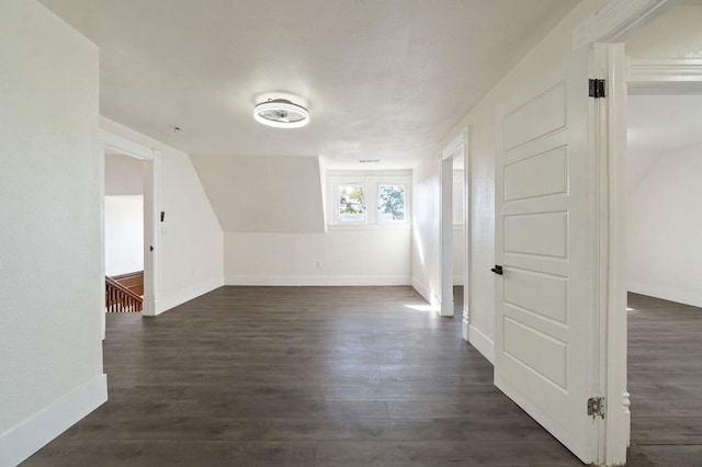 bonus room with dark hardwood / wood-style flooring and lofted ceiling