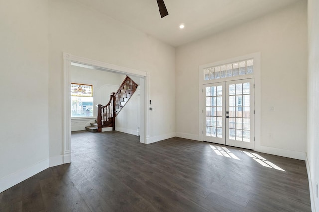 interior space with ceiling fan, dark hardwood / wood-style floors, and french doors