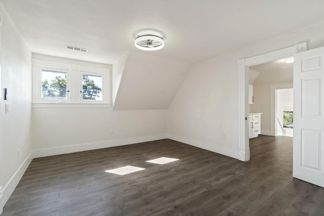 bonus room featuring dark hardwood / wood-style flooring and vaulted ceiling