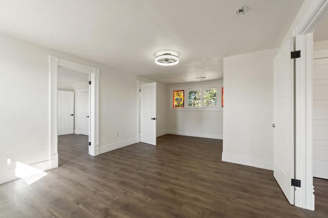 empty room featuring dark hardwood / wood-style flooring