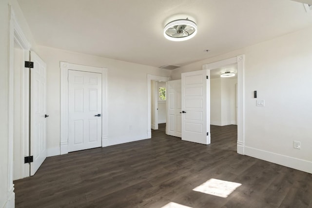 unfurnished bedroom with dark hardwood / wood-style flooring