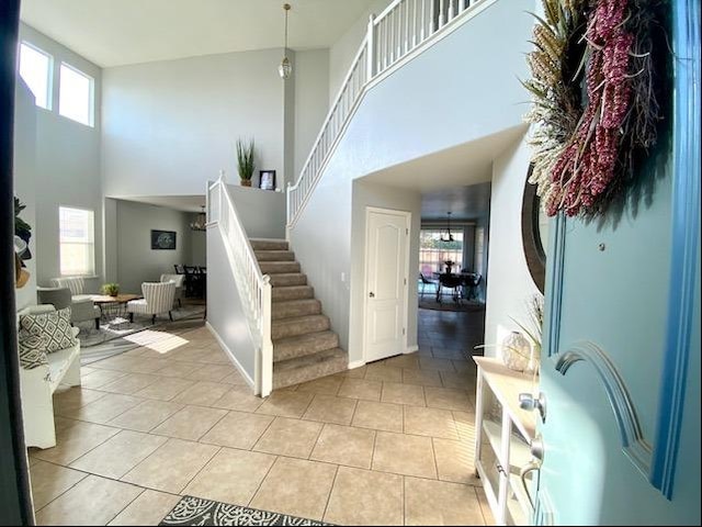 tiled foyer entrance featuring a high ceiling