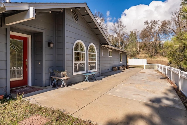 view of side of property with a patio area