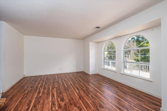 spare room with dark hardwood / wood-style flooring