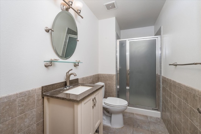 bathroom featuring a shower with door, tile walls, and toilet