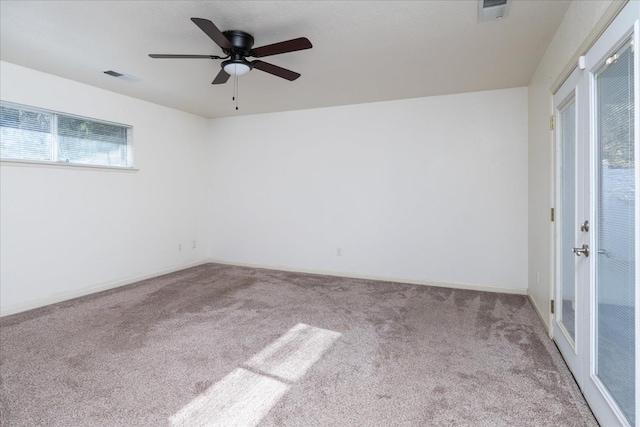 carpeted spare room with ceiling fan