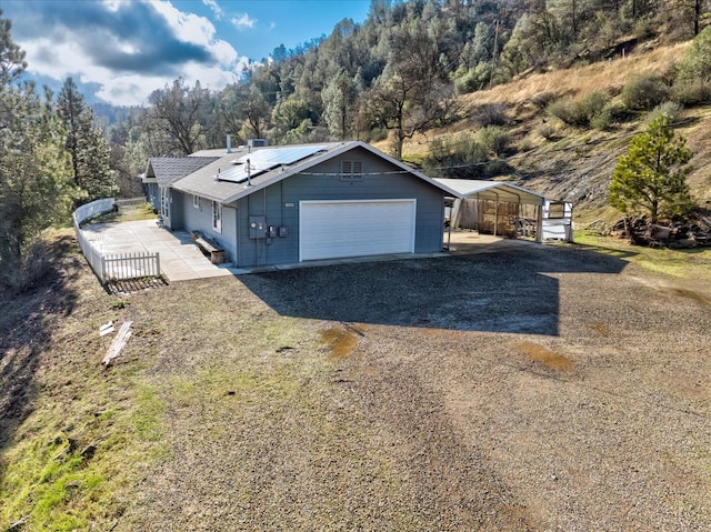 view of front of house featuring a carport and solar panels