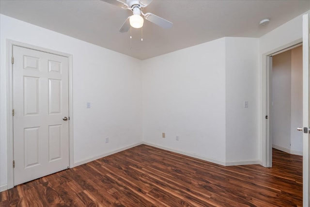 unfurnished room featuring ceiling fan and dark hardwood / wood-style flooring