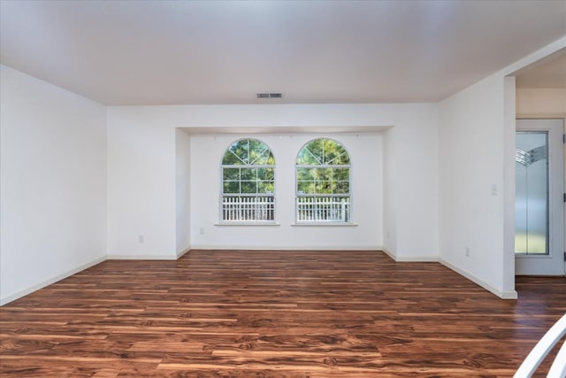 unfurnished room featuring dark wood-type flooring