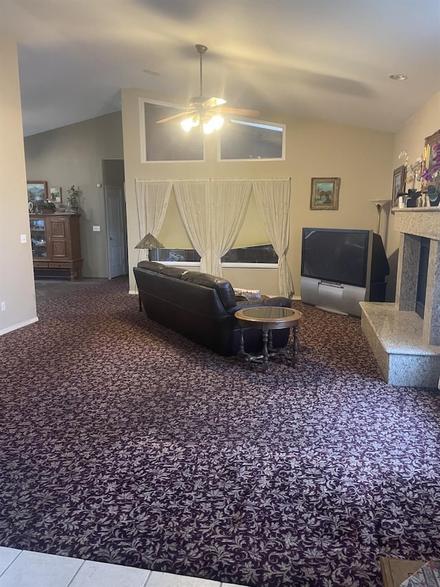 living room featuring ceiling fan, carpet flooring, and vaulted ceiling