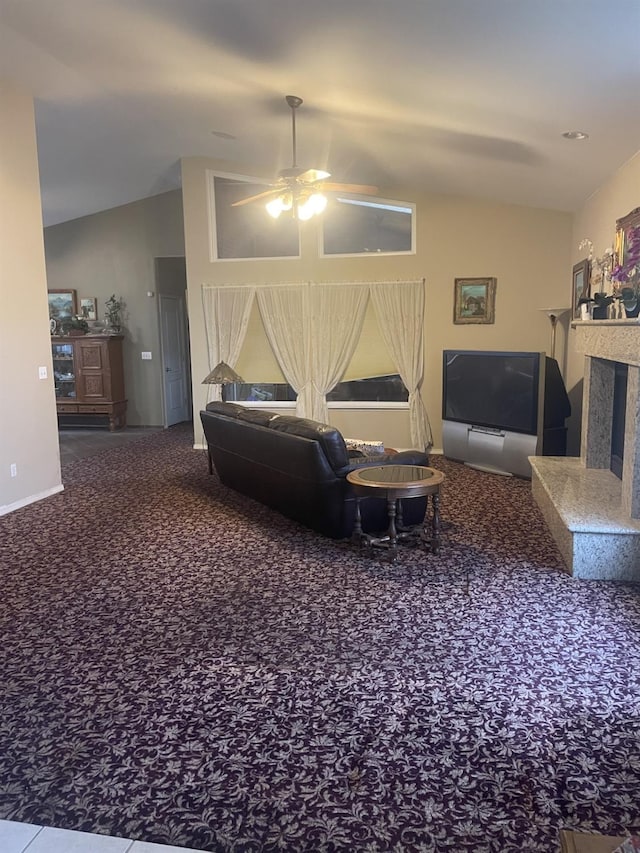 living room featuring ceiling fan, carpet, and vaulted ceiling