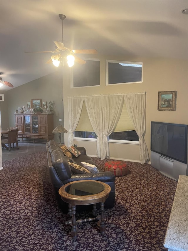 carpeted living room with ceiling fan and lofted ceiling