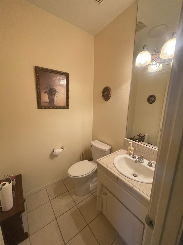 bathroom featuring toilet, tile patterned floors, and vanity