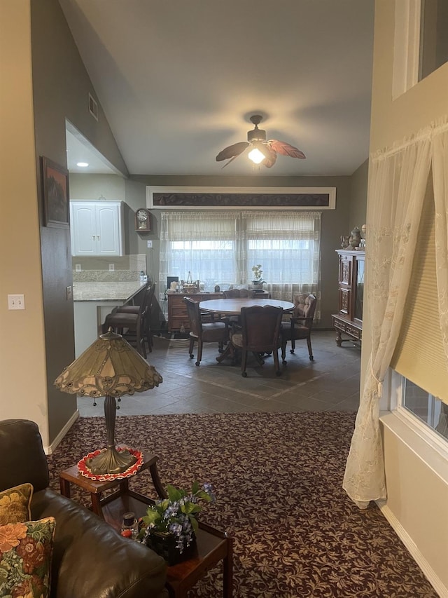 dining room with ceiling fan and vaulted ceiling