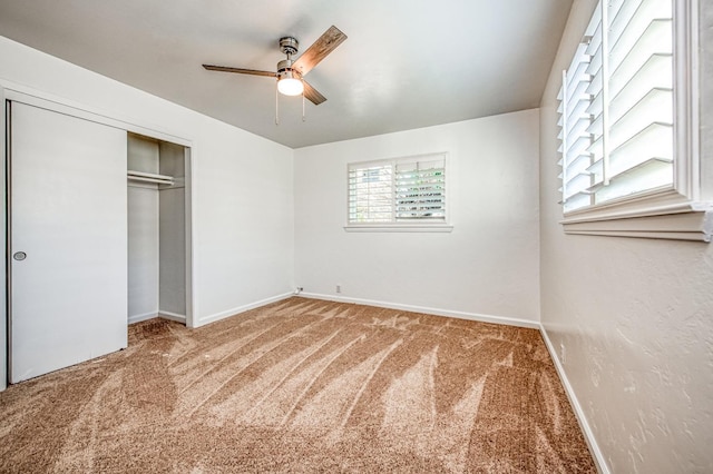 unfurnished bedroom with carpet flooring, ceiling fan, and a closet