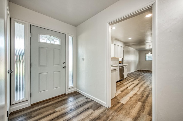 entryway featuring a chandelier and dark wood-type flooring