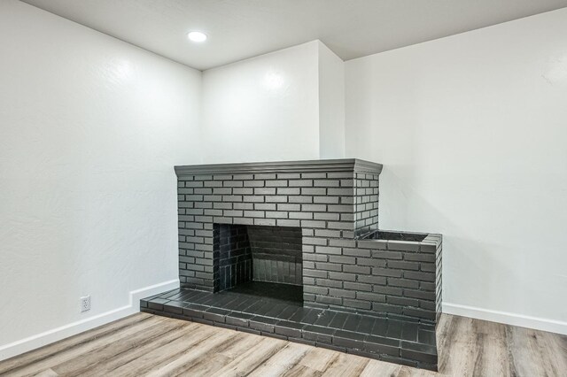 interior details with a fireplace and hardwood / wood-style floors