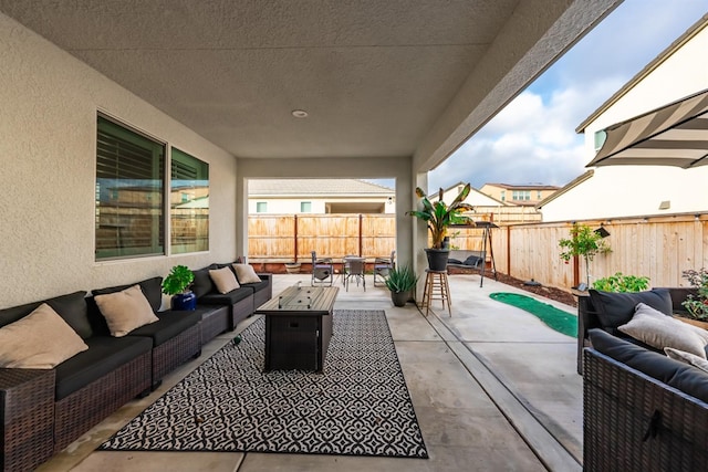 view of patio / terrace featuring an outdoor living space with a fire pit