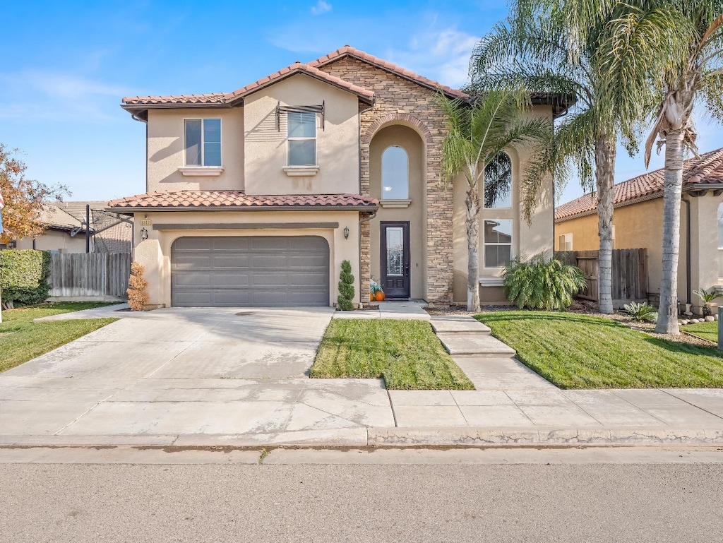 mediterranean / spanish house with a garage