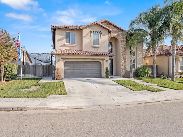 mediterranean / spanish-style home featuring a garage and a front yard