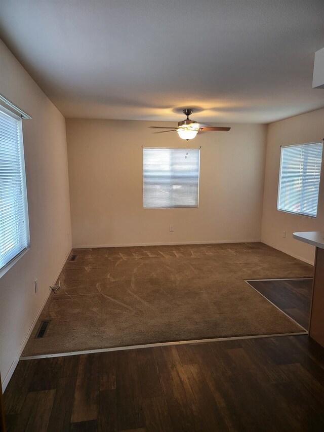 spare room featuring ceiling fan and dark hardwood / wood-style floors