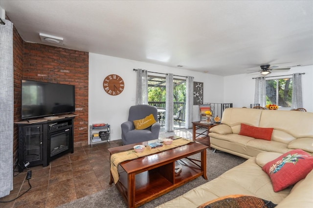 living room featuring a brick fireplace and ceiling fan