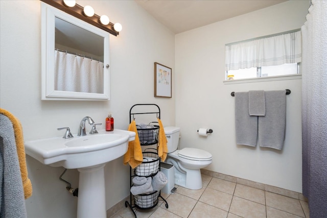 bathroom featuring tile patterned flooring and toilet