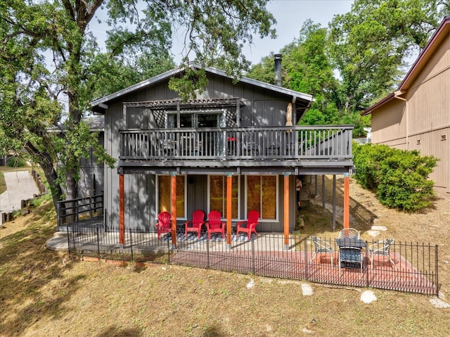 rear view of house with a patio area and a wooden deck