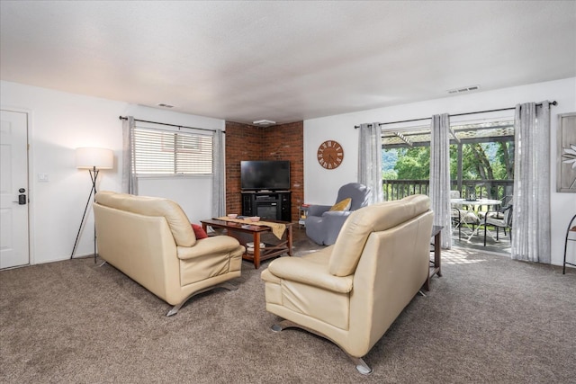 carpeted living room featuring a textured ceiling