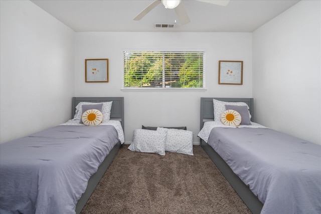 bedroom featuring ceiling fan and dark carpet