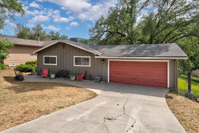 single story home featuring a patio area and a garage