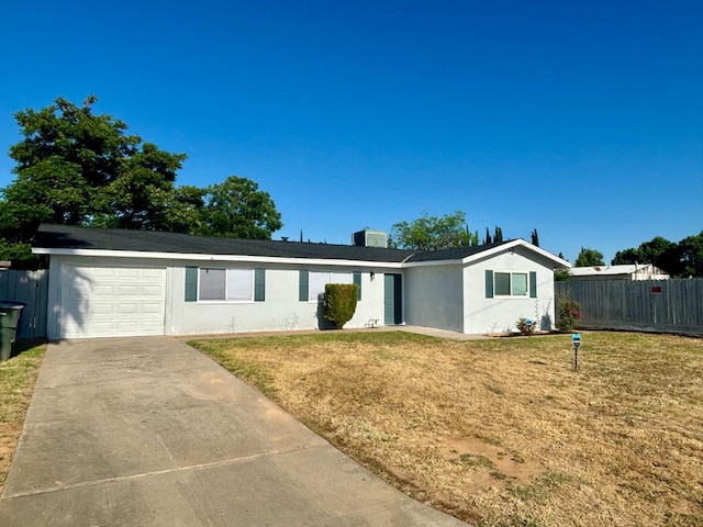 ranch-style house with a garage and a front lawn