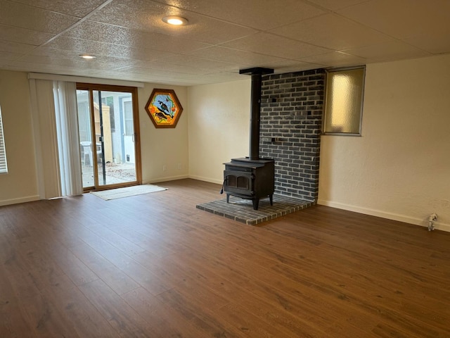 unfurnished living room with dark hardwood / wood-style flooring and a wood stove