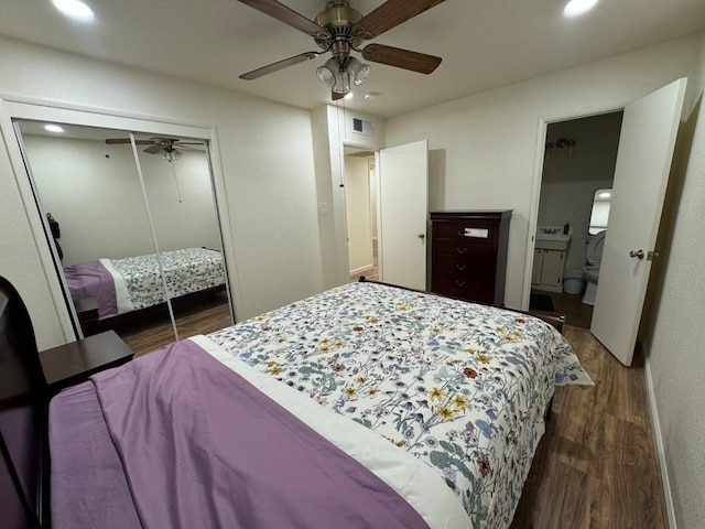 bedroom featuring ceiling fan, dark hardwood / wood-style flooring, and a closet