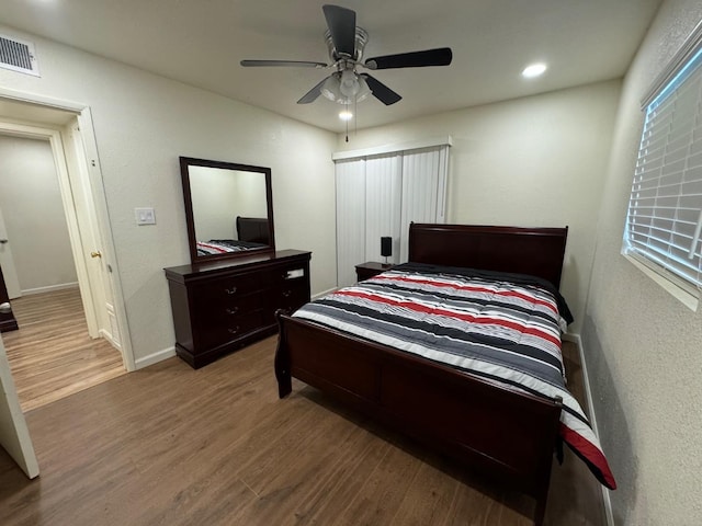 bedroom with hardwood / wood-style floors and ceiling fan