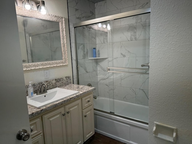 bathroom with vanity and enclosed tub / shower combo