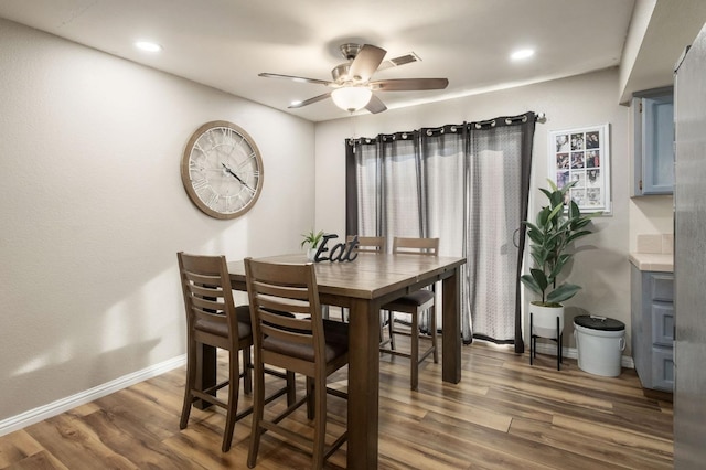 dining room featuring dark hardwood / wood-style flooring and ceiling fan