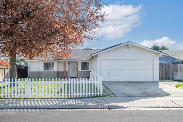 single story home featuring a front yard and a garage