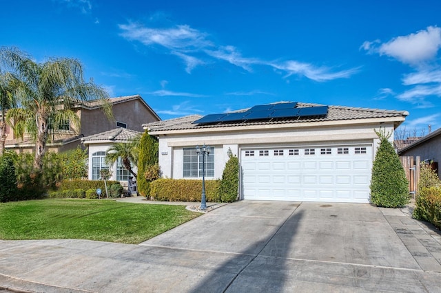 view of front facade featuring solar panels, a garage, and a front lawn