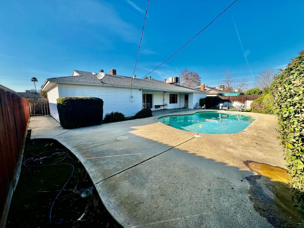 view of pool featuring cooling unit and a patio