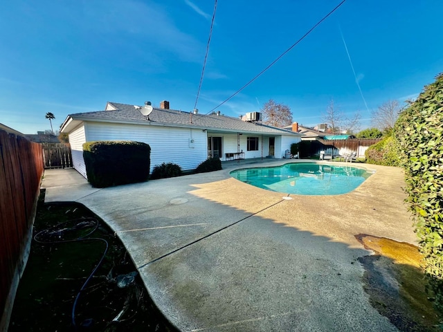 view of pool featuring cooling unit and a patio