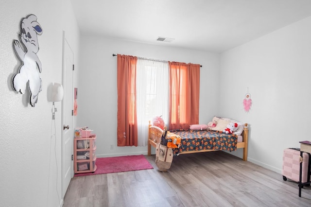 bedroom with light hardwood / wood-style floors